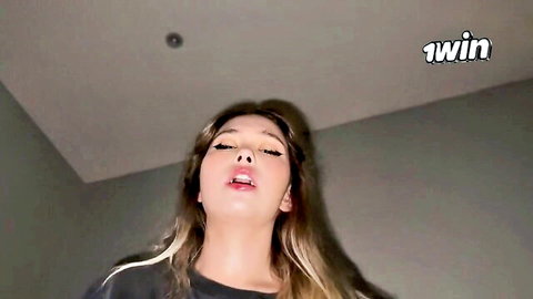Blonde Asian woman with open mouth in arousing home video thumbnail