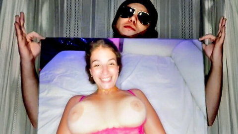 La Sirena 69 topless with huge tits, smiling on bed in steamy amateur scene