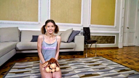 Honeycore skinny Asian teen with pigtails in tank top holding teddy bear