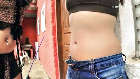 Fit Muay Thai fighter woman exposes toned belly with navel piercing for punch fetish