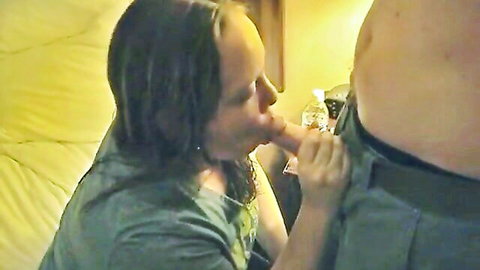 Amateur woman with long dark hair gives blowjob to overweight man