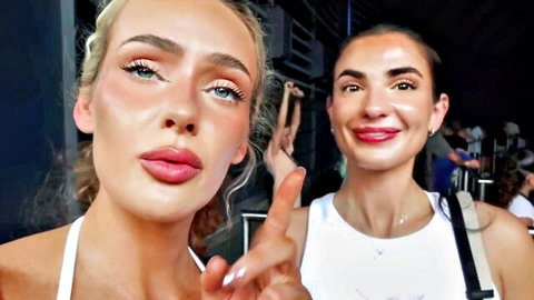 Two smiling besties selfie at Tampa event, blonde and brunette in white tops