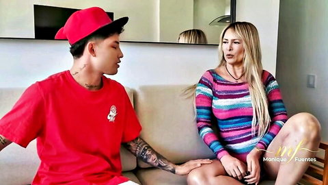 Blonde MILF Monique Fuentes in tight striped top flirts with tattooed Asian guy on couch