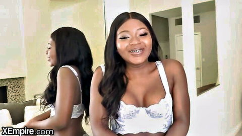 Noemie Bilas smiling in sexy white lace lingerie, showing cleavage