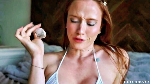 Scarlet Chase redhead in white bikini holding shell, teary closeup Evil Angel