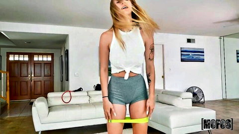Blonde MILF teasing in tied tank top and tight shorts with resistance band