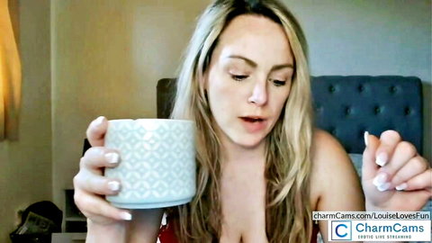 Blonde camgirl LouiseLovesFun seductively sipping mug in erotic webcam show