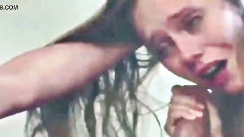 Amateur woman with long dark hair in intense facial expression during rough threesome