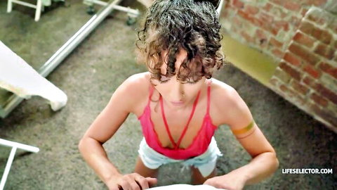 Curly-haired beauty in pink bra and tiny white shorts bending over seductively