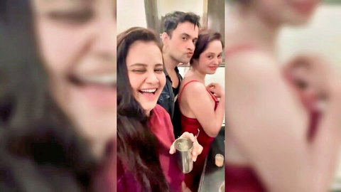 Priya Gamre and Ritu Rai in red dresses with man, smiling intimately
