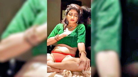Sexy Indian babe in green sequined blouse and red panties, sitting seductively