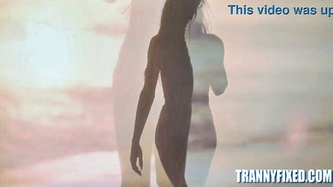 Erotic nude trans silhouette with curves strutting on sunset beach