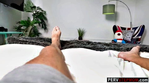 POV of stepson's bare legs spread wide on pervy stepmom's bed teasing cock
