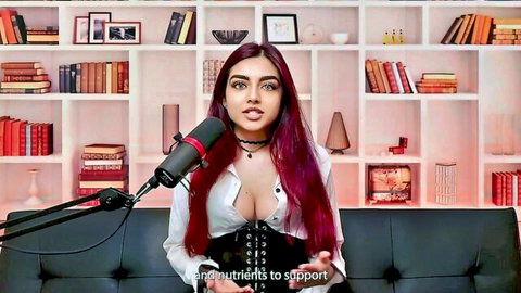 Zara Dar in deep cleavage white blouse and black corset, discussing muscle growth science