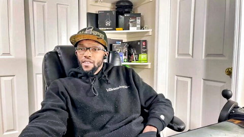 Imaginaryninja black man in hoodie cap glasses, casual pose