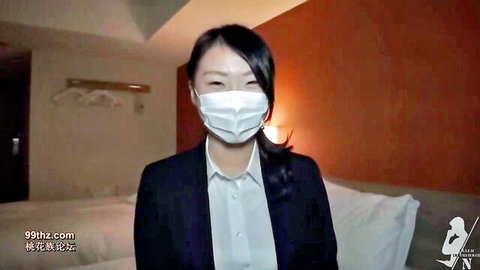 Black-haired Japanese student Chiharu in mask and suit on bed webcam