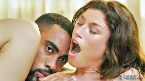 Brunette white girl moans mouth open as muscular black man kisses her neck passionately