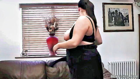 Brunette BBW exposing huge tits in black dress pose