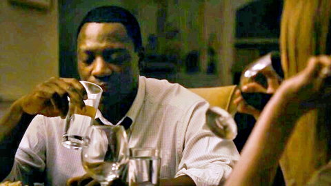 Jennifer Ehle as Kate sharing drinks with black man in intimate dinner scene