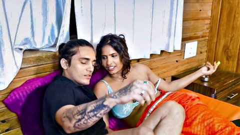 Intimate Indian couple with curvy babe in blue bra and orange skirt beside tattooed hunk