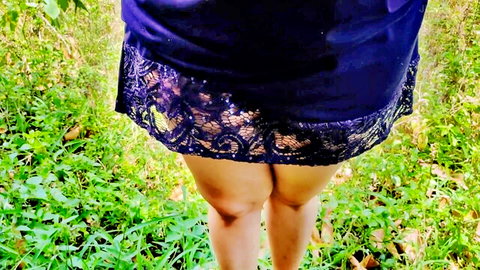 Sexy South Asian wife teasing round ass in short lacy purple skirt outdoors