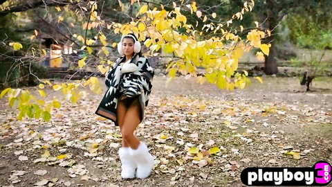 Ebony babe with big tits inviting striptease in autumn outdoors