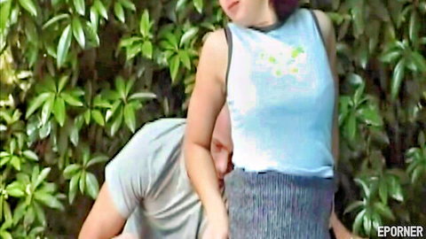 Retro beauty in tank top and skirt sucking stranger's cock outdoors