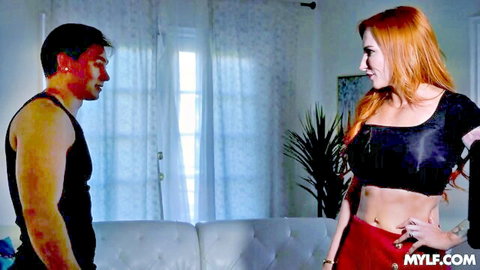 Sophia Locke in black crop top and red skirt teasing muscular man