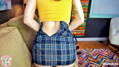 Emma Choice teasing from behind in short plaid skirt and crop top