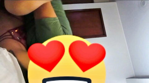 Two sexy babes cuddling passionately with heart eyes emoji overlay