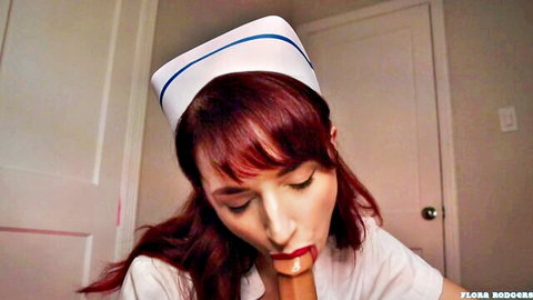 Flora Rodgers as seductive redhead nurse teasing with lips in tit fuck scene