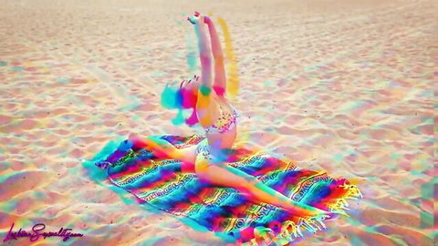 Tanned skinny babe in tiny pink bikini does wide splits on beach blanket showing camel toe