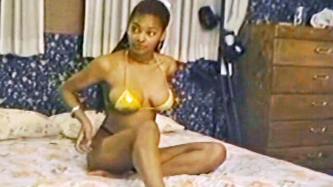 Gorgeous ebony seductress in yellow bikini posing seductively