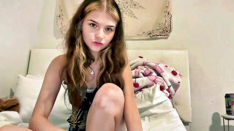 Dobletrouble camgirl in black top on bed, long wavy hair, seductive gaze