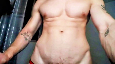 Muscular shirtless hunk in low red underwear exposing pubes and ripped abs in shower selfie