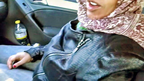 Souzan Halabi smiling in car, hijab and leather jacket, public amateur tease