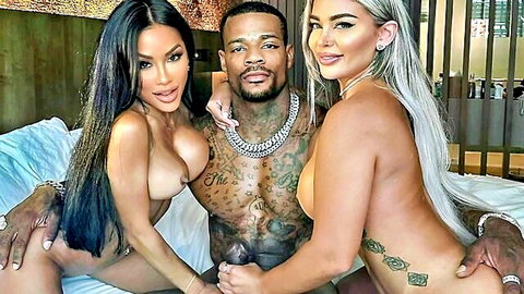 Busty Asian and blonde women with tattooed black man in steamy threesome bed scene