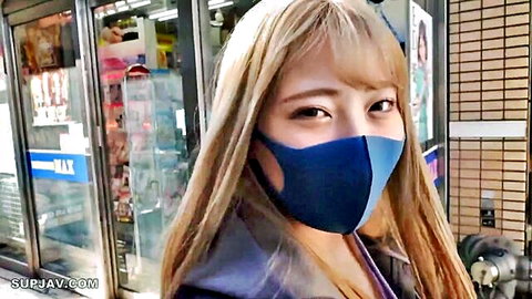 Masked blonde Asian woman in casual jacket outside store, amateur JAV tease