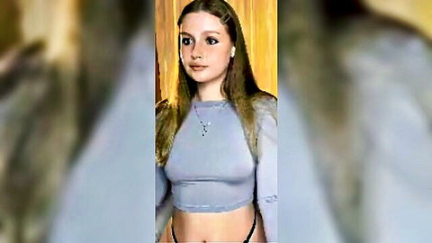 Slim young blonde in grey crop top and low-rise underwear tease