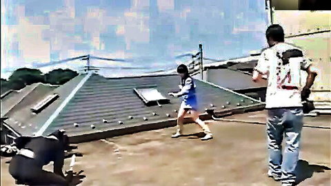 Asian woman in blue mini dress chased by gorilla-suited man on rooftop