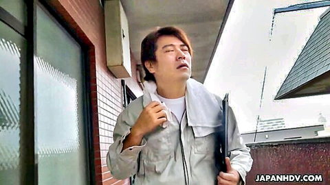 Mulan as sweaty Asian man in gray uniform wiping brow outdoors