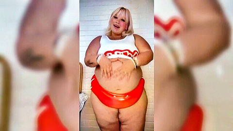 Smiling blonde BBW in white top and red bikini bottoms