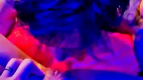 Blurry Asian woman in red outfit solo masturbating under neon lights