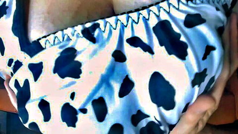 Busty Asian woman in cow print bikini top showing cleavage