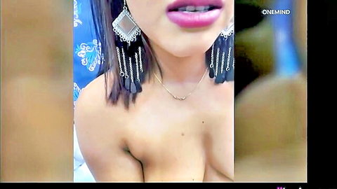 Topless babe with dangling earrings pouting glossy lips and exposing perky tits closeup