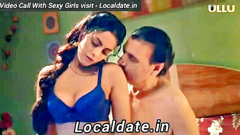 Sexy Indian babe in tight blue bra passionately kissing shirtless man's neck in bedroom
