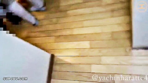 Blurry amateur clip of clothed East Asian woman sitting on wooden stairs