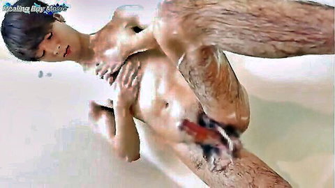 Slim Asian twink anally penetrated in soapy bathtub by hairy man
