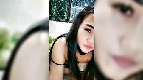 Seductive Asian woman in black lingerie and choker, teasing close-up pose