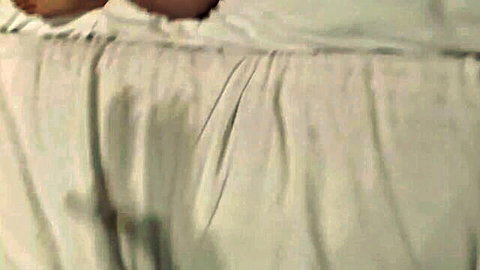 Amateur Japanese woman lying nude on bed, sensual pose